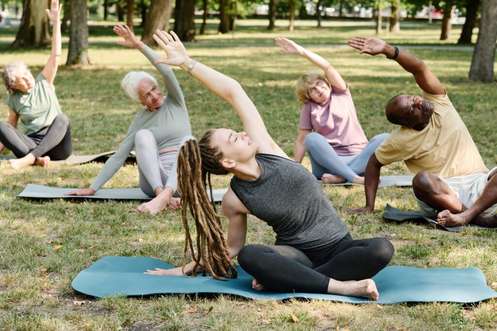 People doing stretching exercises with coach